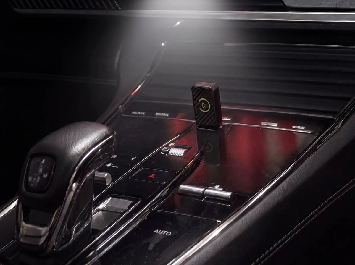 The adapter plugged into the car's USB port with CarPlay on the screen