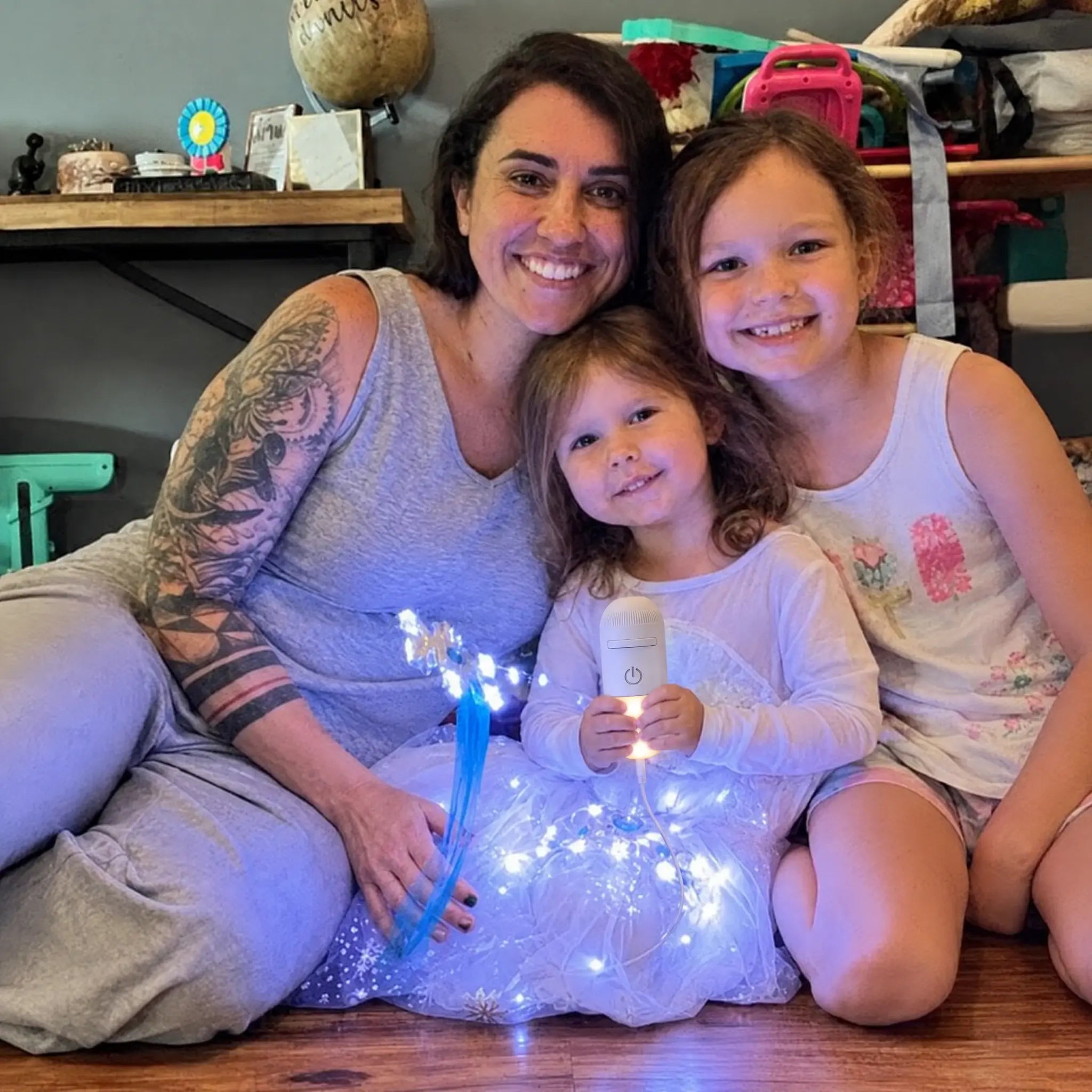 Mother and two daughters with the projector lit at bedtime