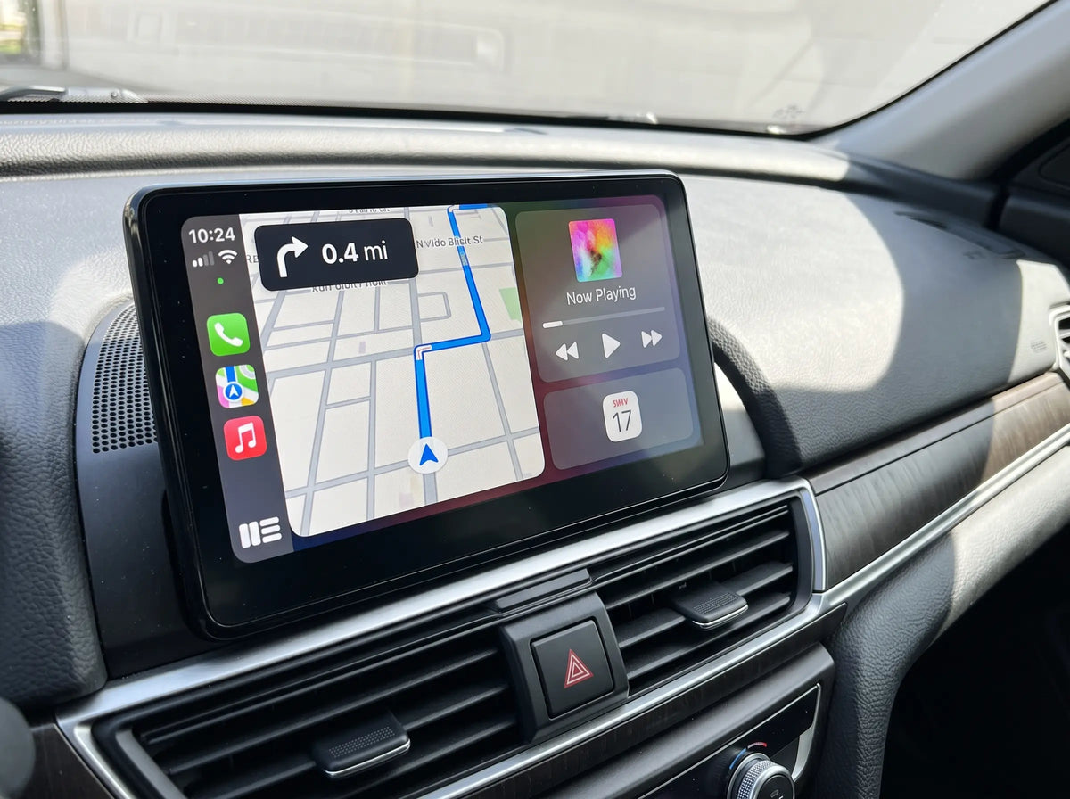 Adapter plugged into the car's USB port with CarPlay on the screen