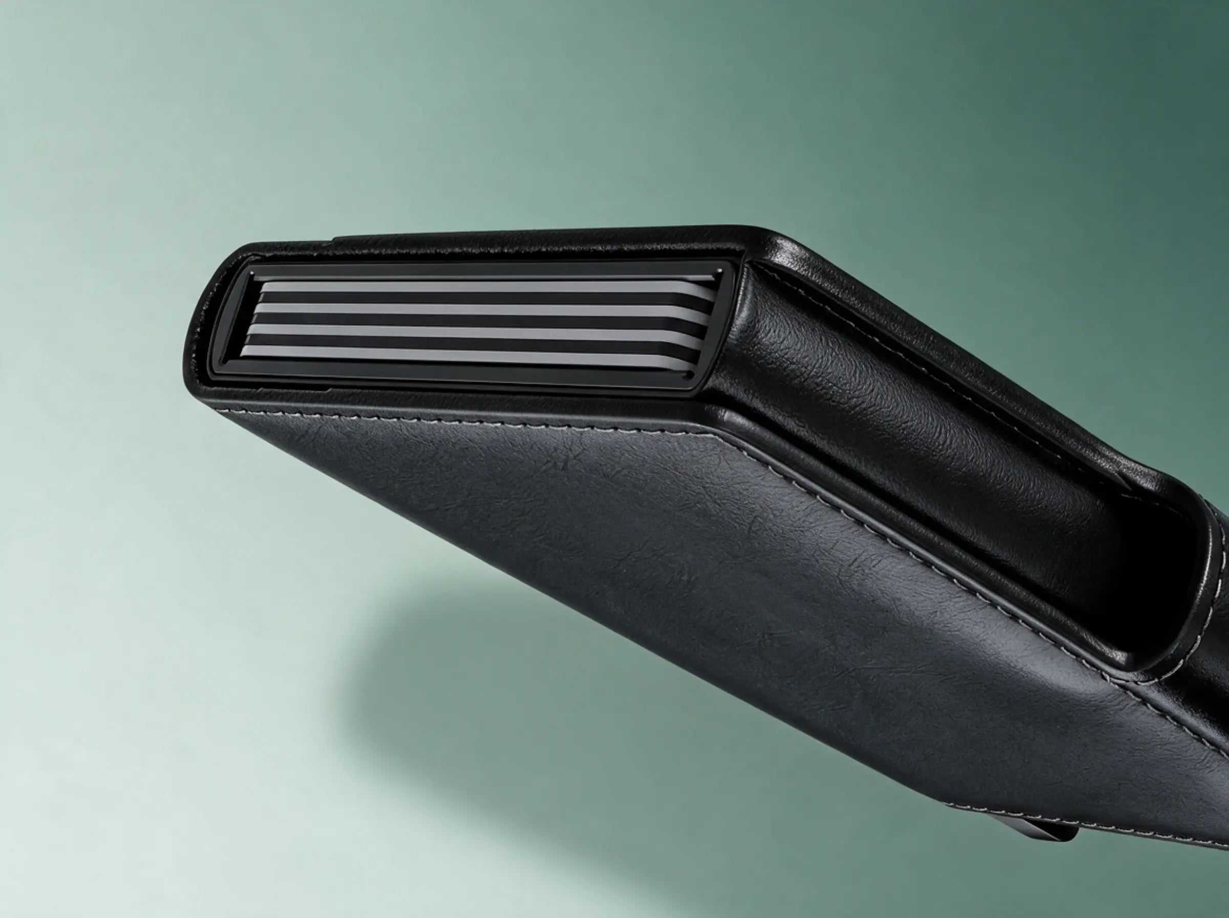 Close up of the aluminium card carrier with the stacked card edges showing